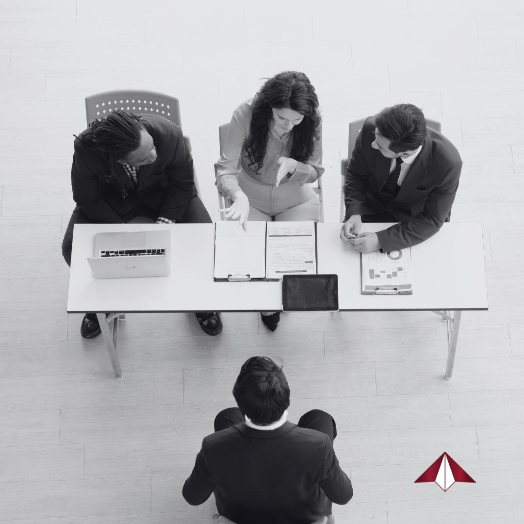 Senior executive in interview preparation session with a coach, reviewing leadership talking points and practicing mock interview questions.