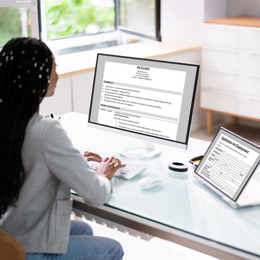 Professional woman writing her CV on a laptop, preparing to work with a Pro CV Writer to boost her chances in a competitive job market.